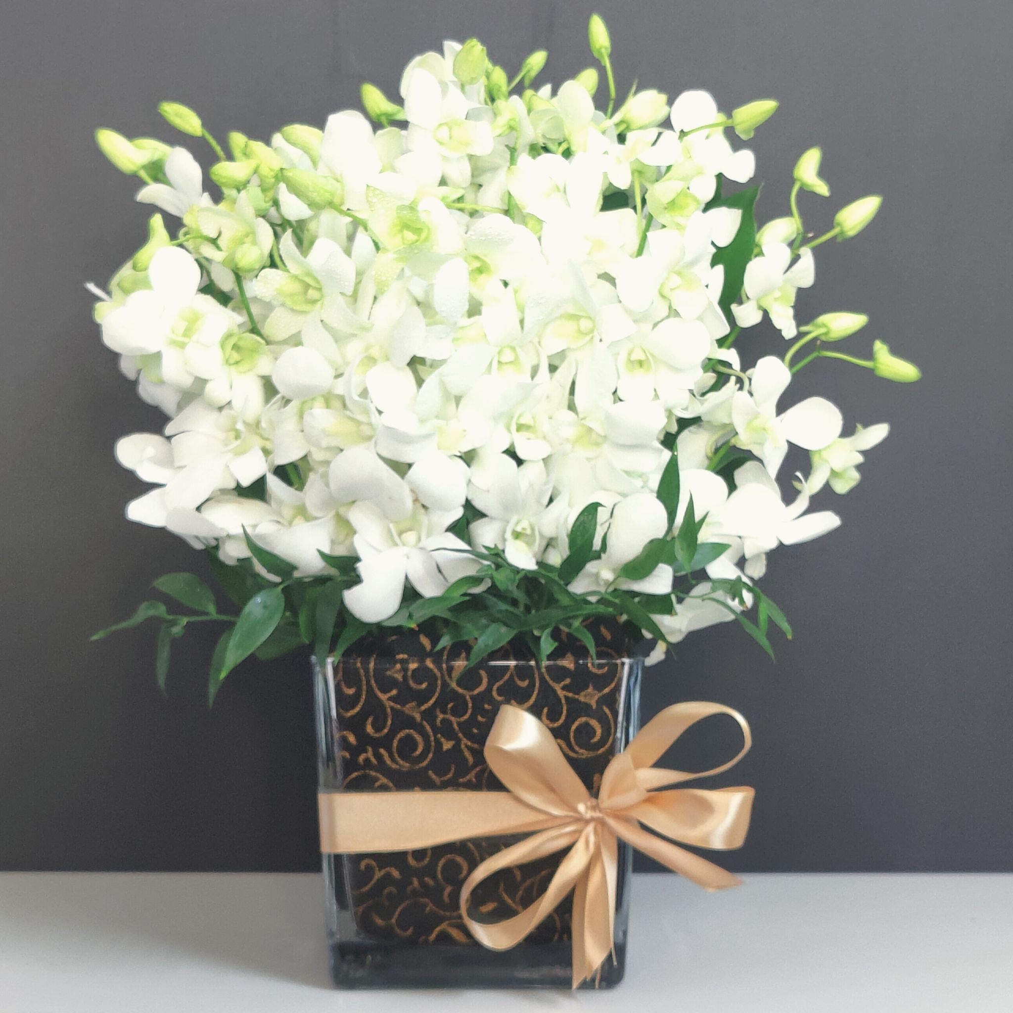 send flowers Sharjah White Orchids in Black Vase