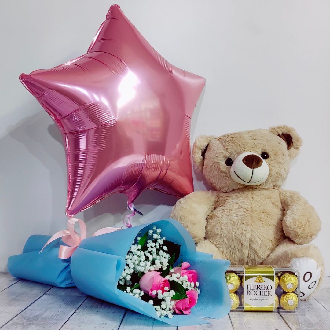 women’s day combo gift of pink roses bouquet, teddy and chocolate.