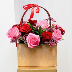 12 Pink and Red Roses arranged in a Bag